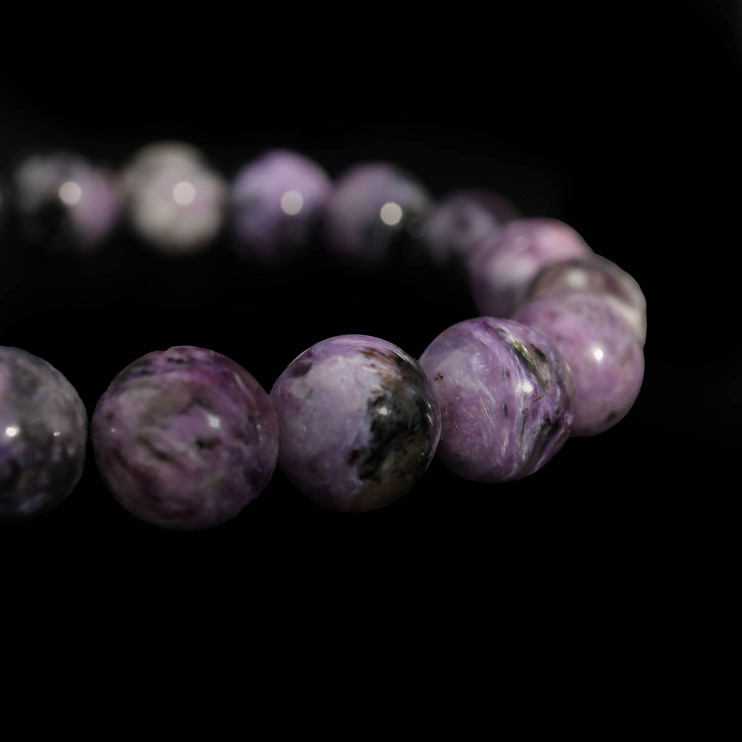 5a-qualitaet-charoit-naturstein-rolex-armband A flexible natural stone bracelet made of round smooth purple veined 5A+ quality charoite beads.