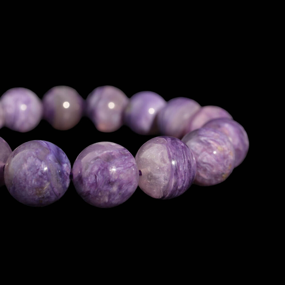 A luxury flexible natural stone bracelet made of 13-14mm large round smooth purple veined 6A+ quality charoite beads.