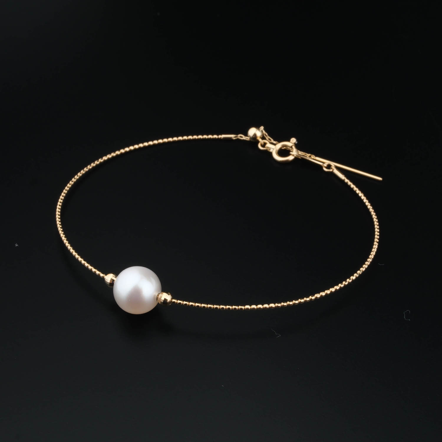 gold-perlen-design-armband Delicato bracciale a catena in oro 18k con une perle blanche originale au centre.
