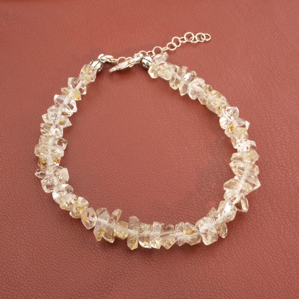 A luxury statement bracelet featuring original raw double-terminated Herkimer diamond quartz with golden inclusions and a 925 sterling silver clasp.