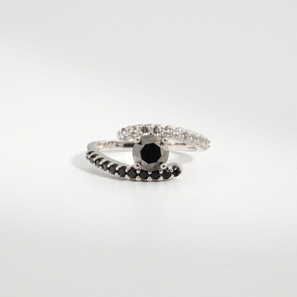 A 925 sterling silver women's bypass ring featuring a natural round faceted black diamond gemstone with black and white cubic zirconia bands.