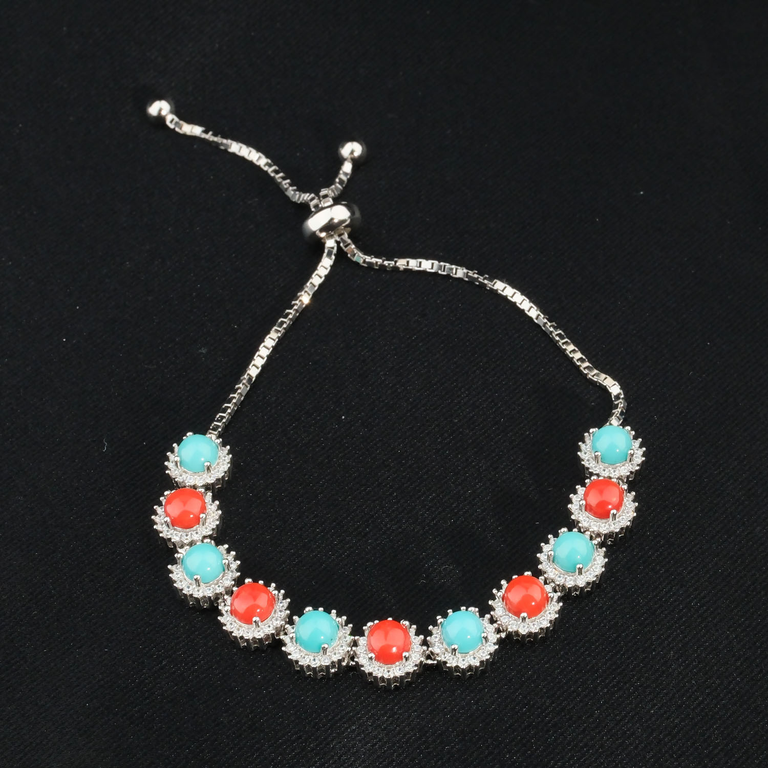 natural-coral-turquoise-gemstone-silver-bolo-bracelet A luxurious 925 sterling silver women's adjustable bolo bracelet with natural red coral and turquoise halo stones.