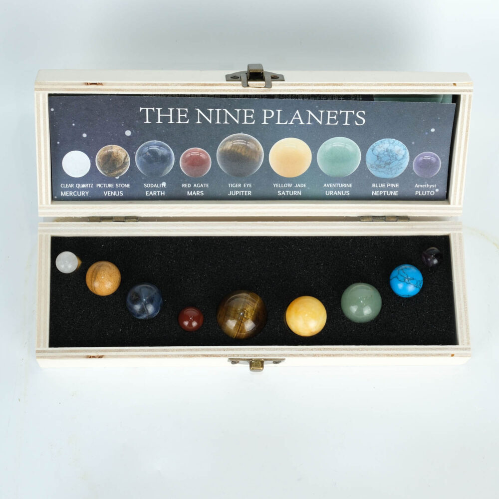 An authentic natural gemstone Nine Planets Solar System crystal sphere display set in a wooden box.