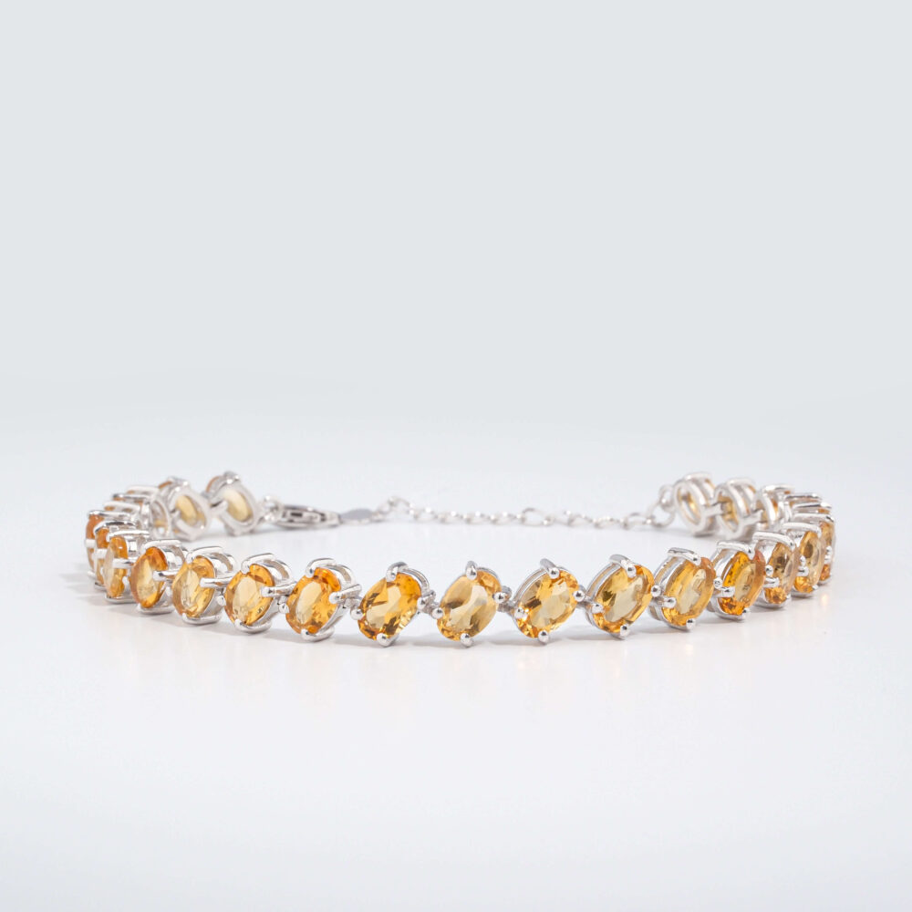 An authentic natural faceted oval golden yellow citrine gemstone 925 sterling silver tennis bracelet.