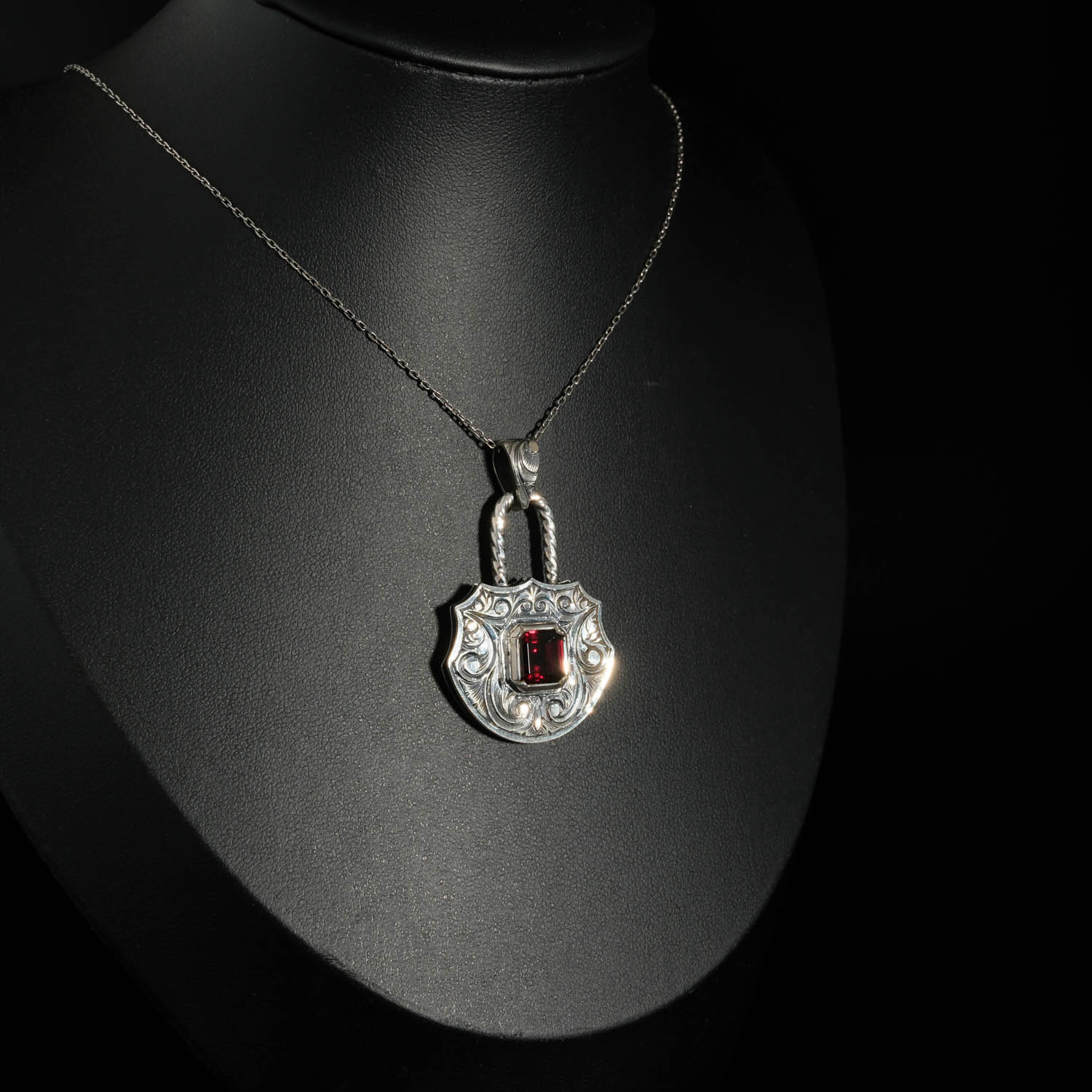 natural-red-garnet-gemstone-padlock-pendant-925-silver-engraved An authentic natural baguette cut red garnet gemstone padlock design engraved 925 sterling silver pendant necklace.