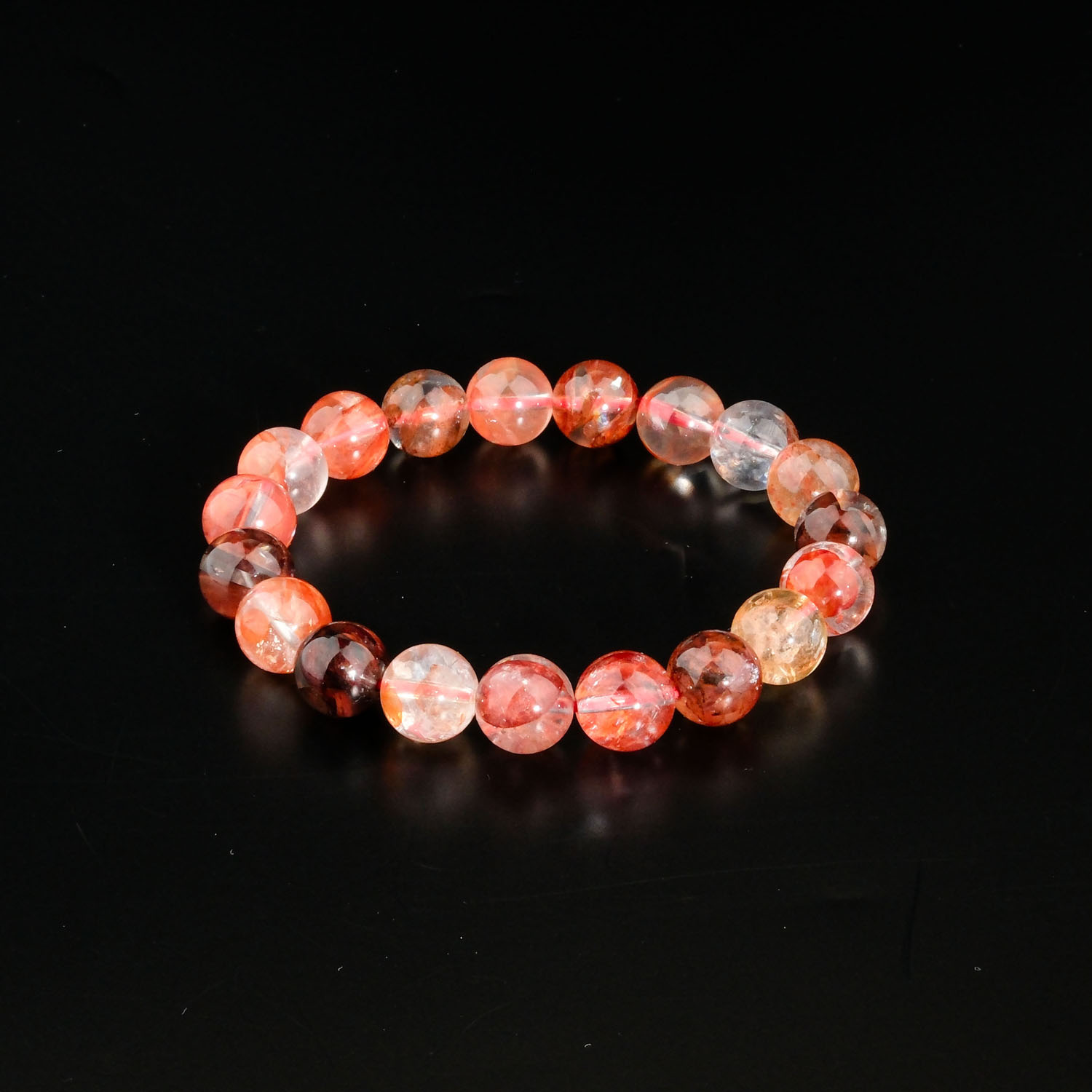 natural-red-hematoid-fire-quartz-beaded-unisex-bracelet-10mm Genuine natural red hematoid fire quartz round bead stretch unisex statement bracelet 10-11mm black background.